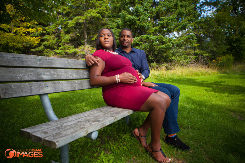 Maternity Photo Husband Wife Sitting on park bench in Ajax
