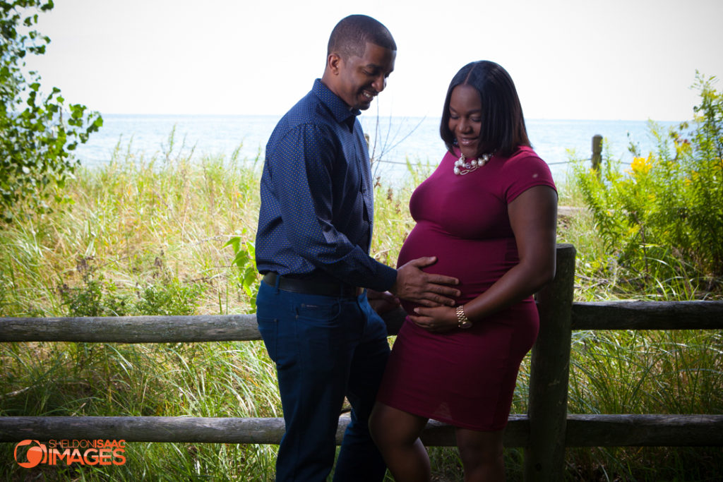 Maternity Photo smiling husband looking at baby bumb