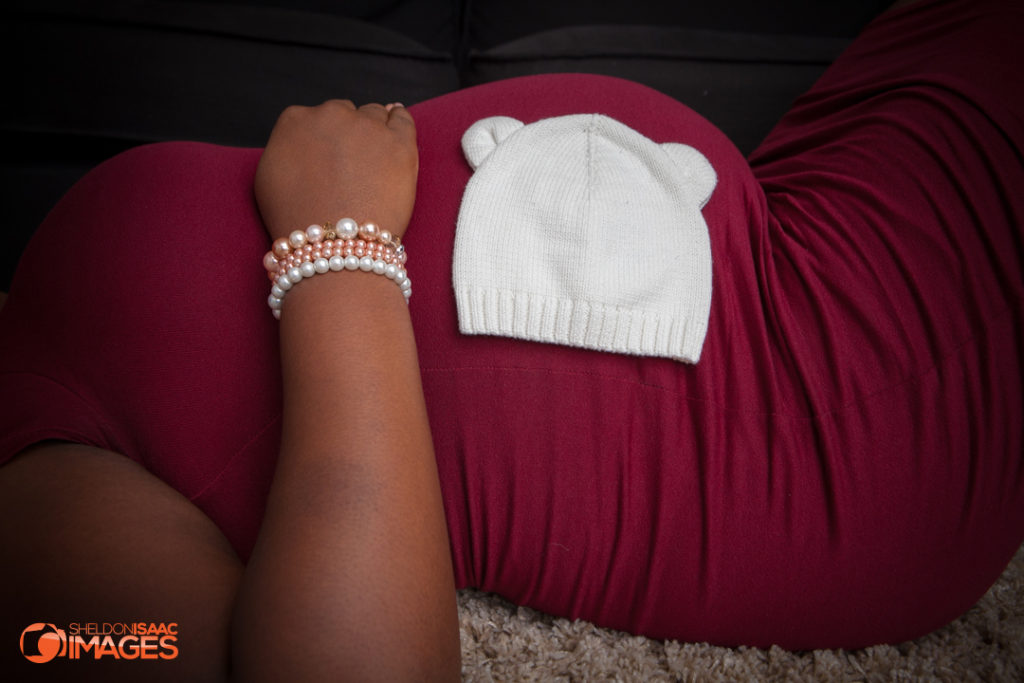 Maternity Photo baby hat on mothers stomach