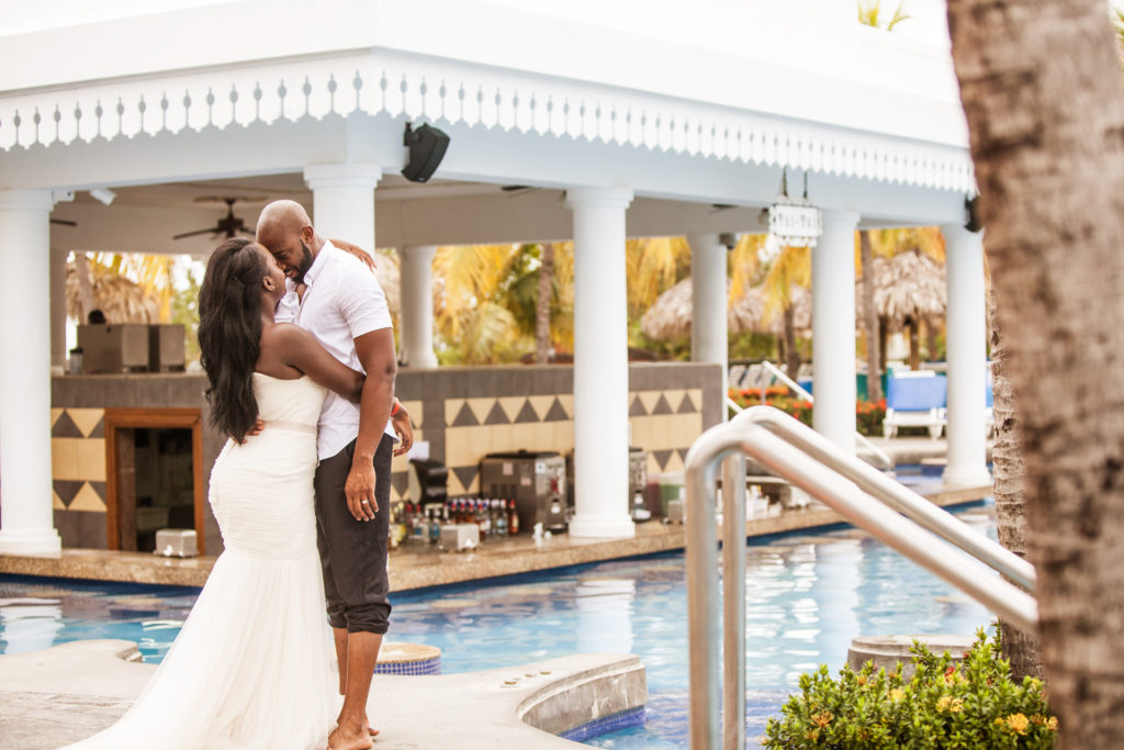 Bride and Groom hugging by the pool bar