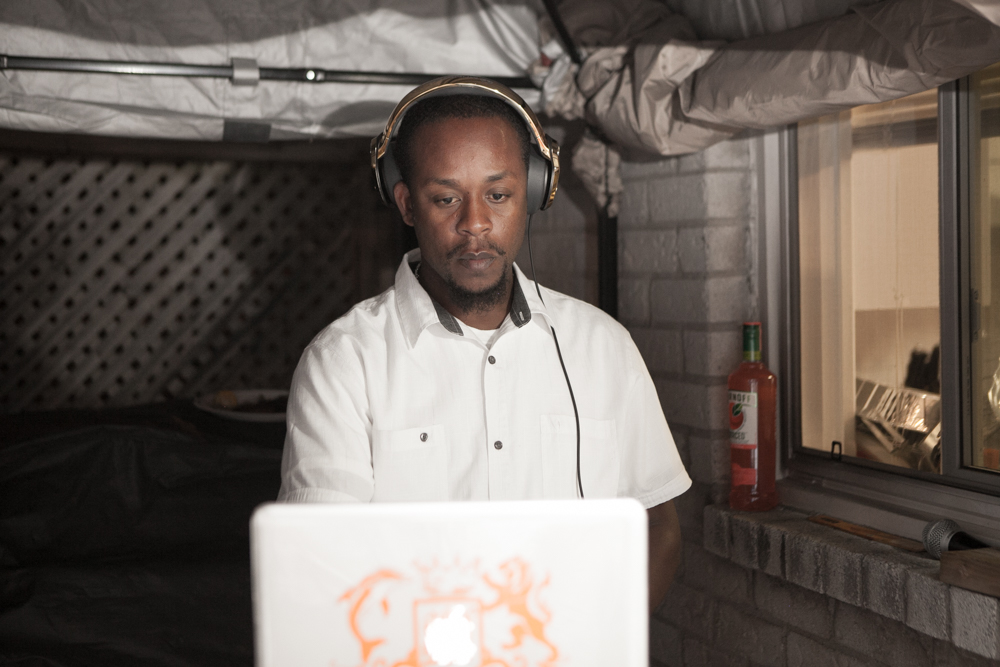 DJ Skin playing music on his laptop