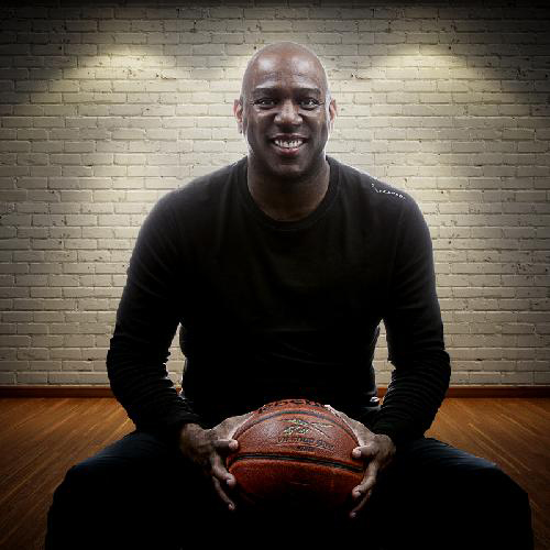 Physiotherapist smiling with a basketball in Newmarket