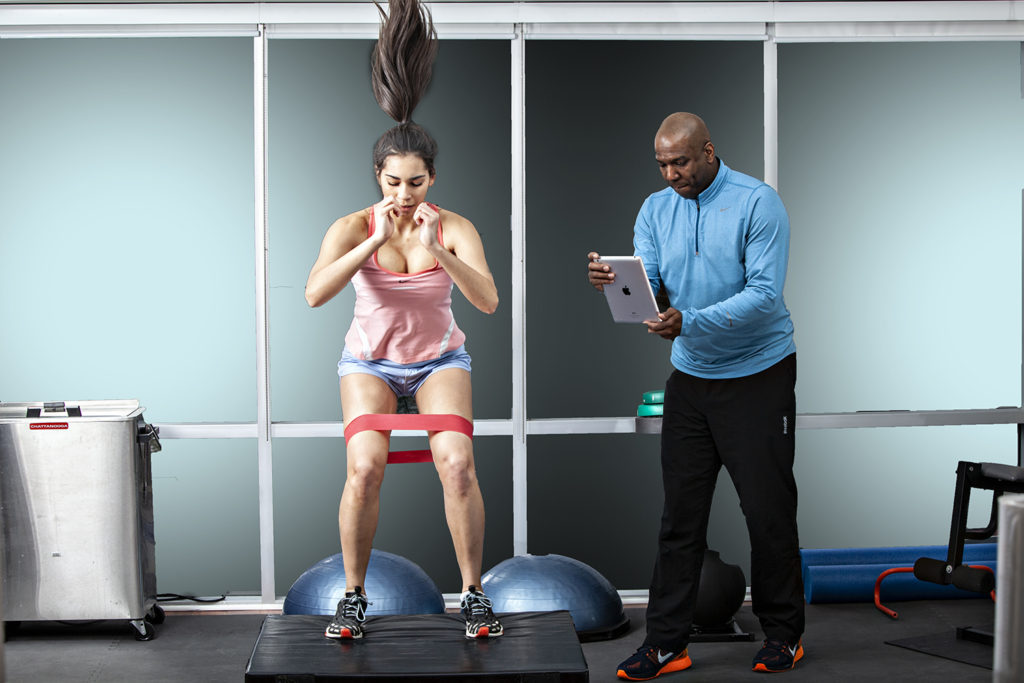 Physiotherapist working with a client to increase strength in Aurora