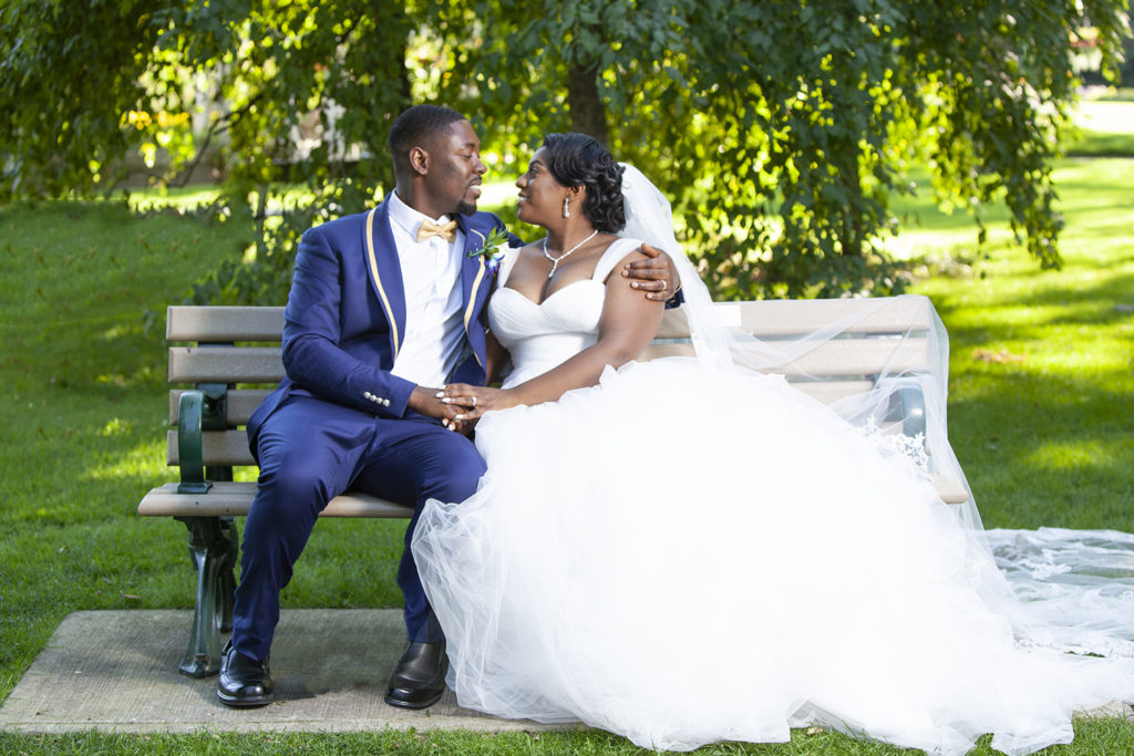 Husband and Wife smiling at each other at Rosetta Mclain Gardens in Toronto by wedding photographer Sheldon Isaac Images