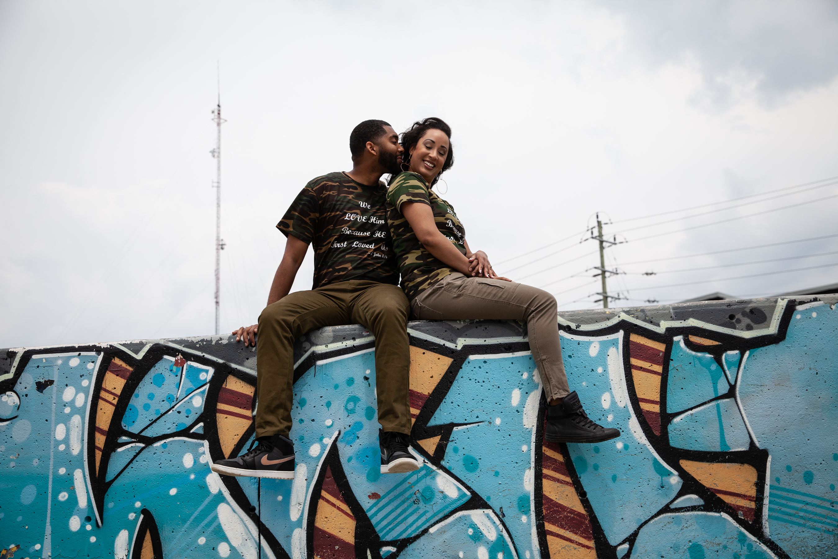 Couple sits on a skate park wall in Whitby during their Engagement photoshoot with Sheldon Isaac Images
