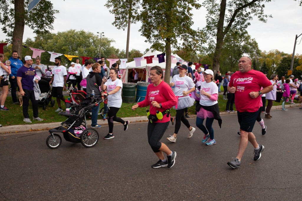 Lady pushing a stroller in the CIBC Run for the Cure in Oshawa