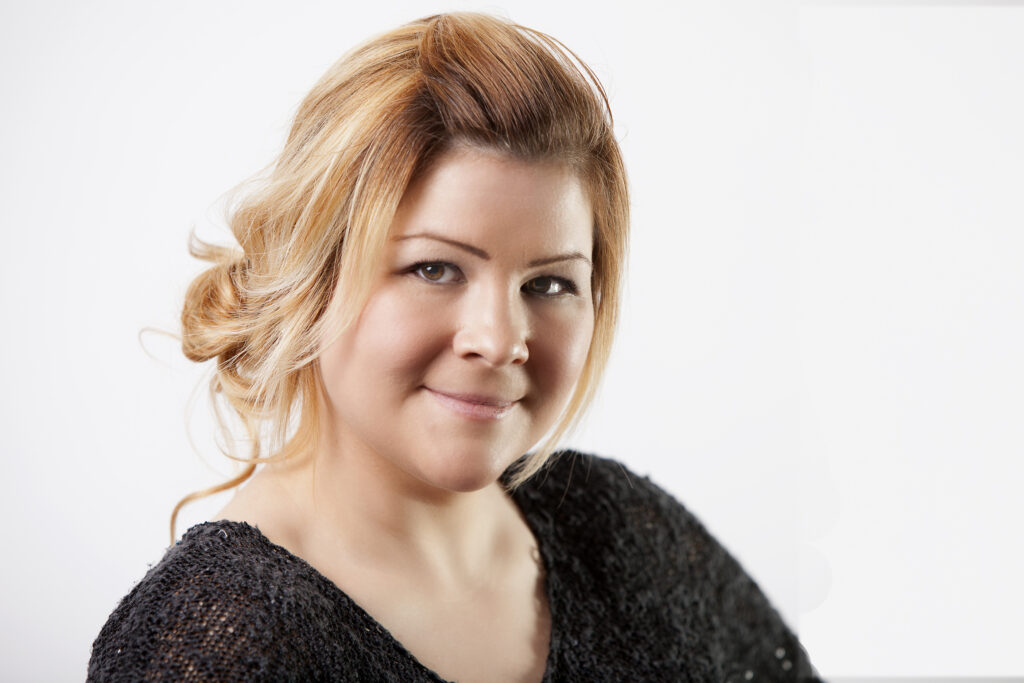 Young woman smiles for her headshot photo in Ajax.