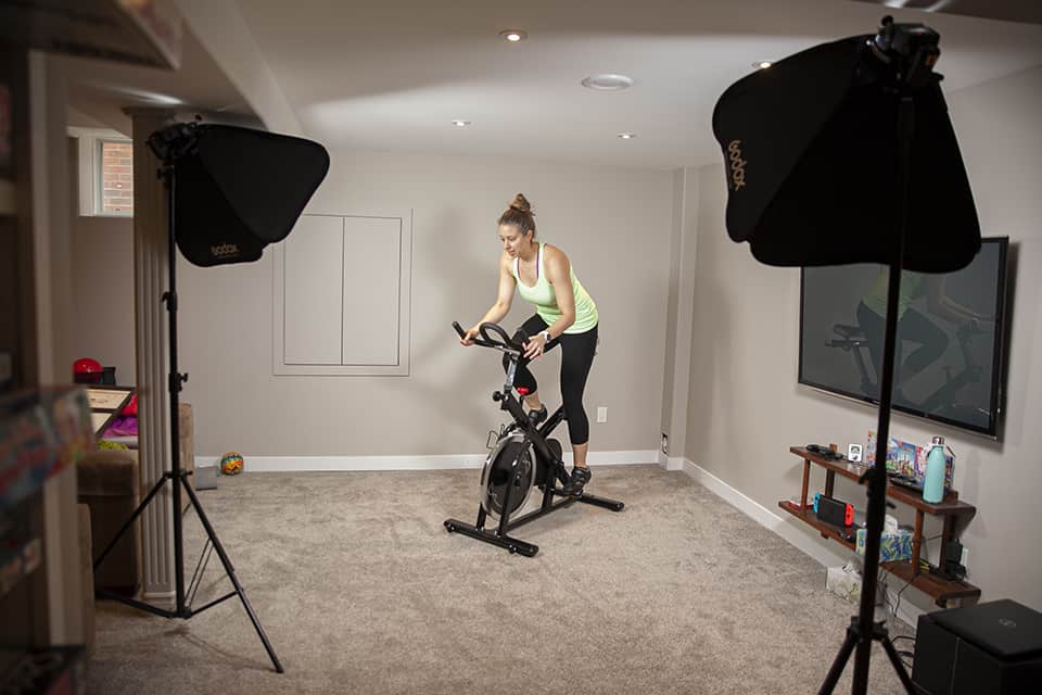 Health Coach riding an exercise bike at a Brooklin Branding photoshoot