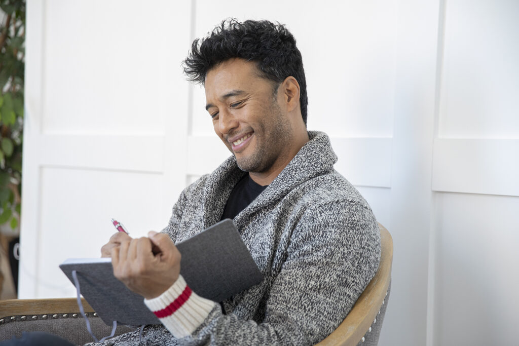 Actor smiling while reading during a portrait photoshoot