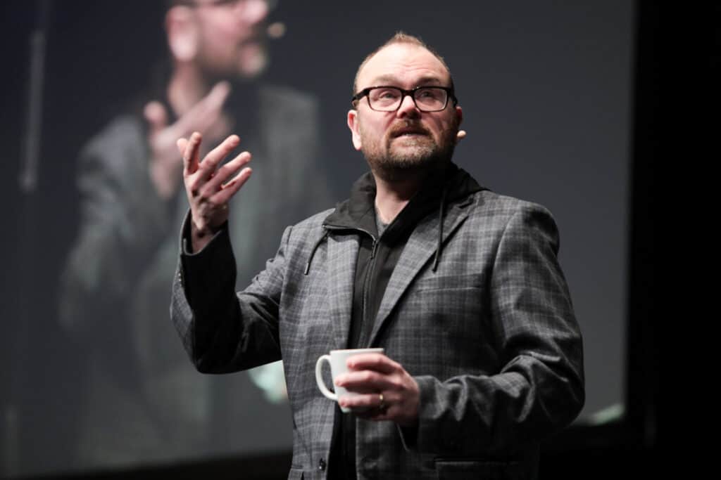 Man speaking to large audience in Ajax Ontario