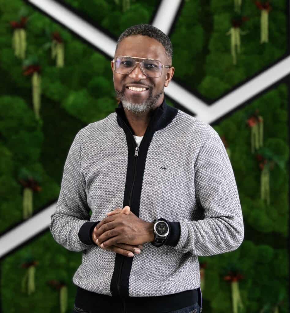Corporate event photographer Toronto - portrait of Sheldon Isaac against a green moss wall
