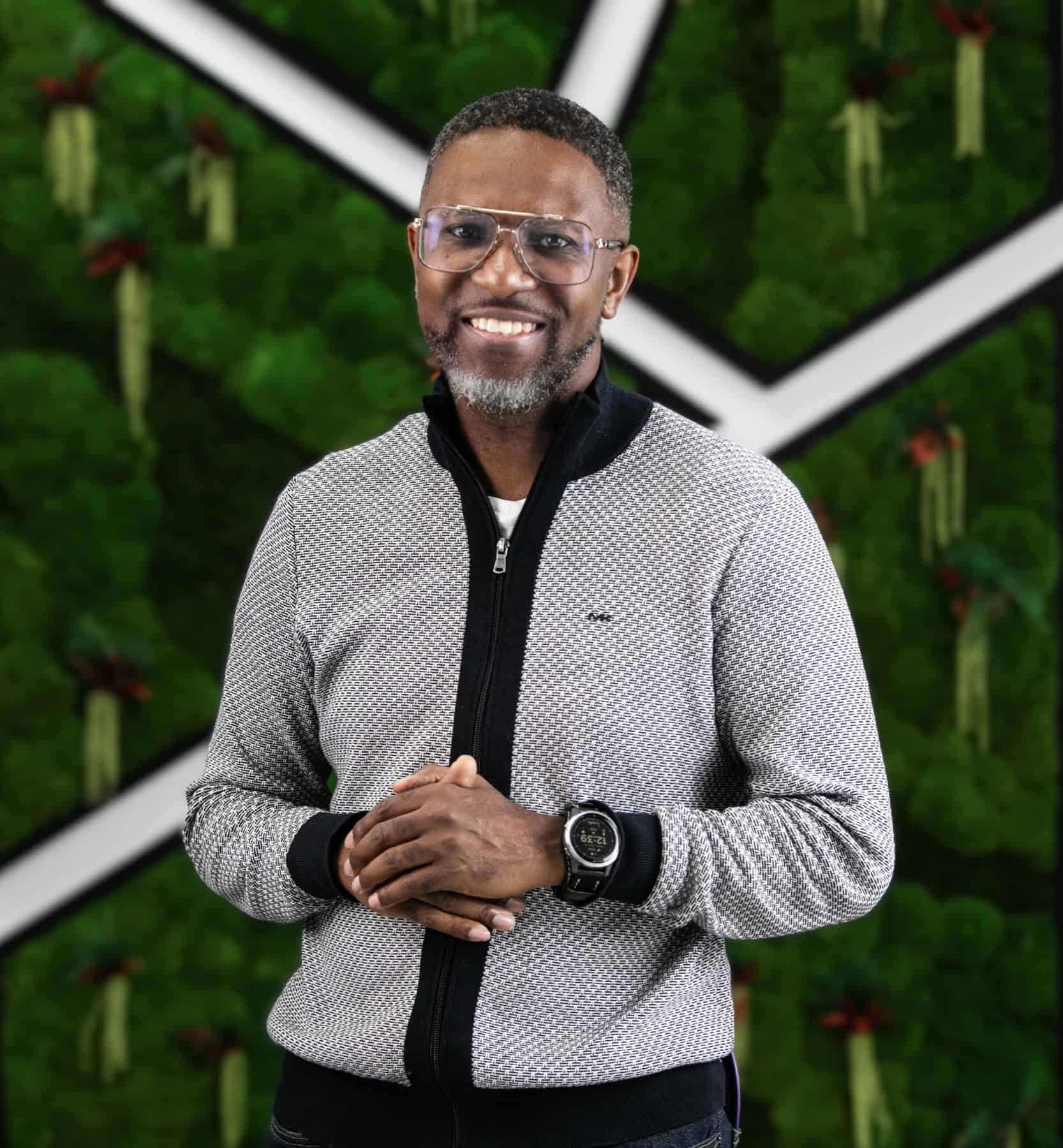 Corporate event photographer Toronto - portrait of Sheldon Isaac against a green moss wall