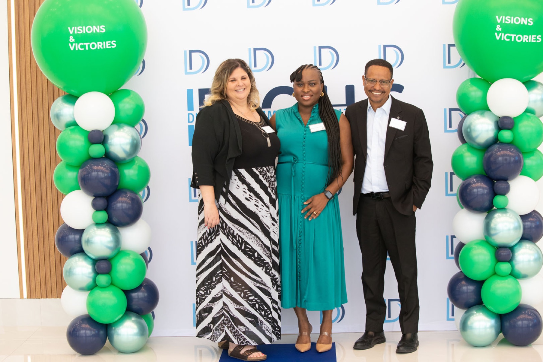 Corporate event photographer Toronto — guests at a branded sponsor backdrop