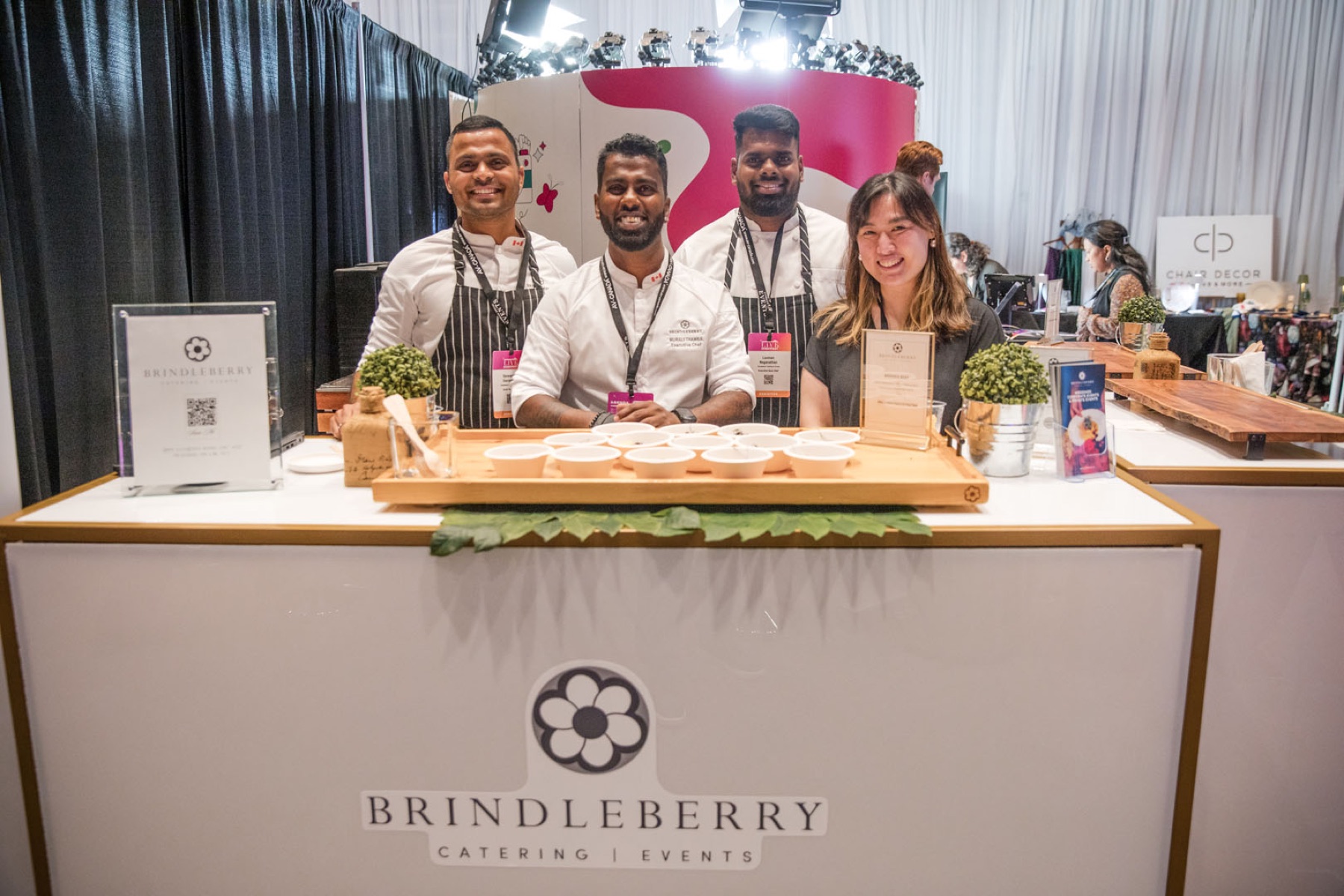 Trade show photographer Toronto — exhibitors at a branded booth