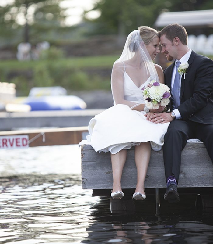 Bride and Groom sitting near the water
