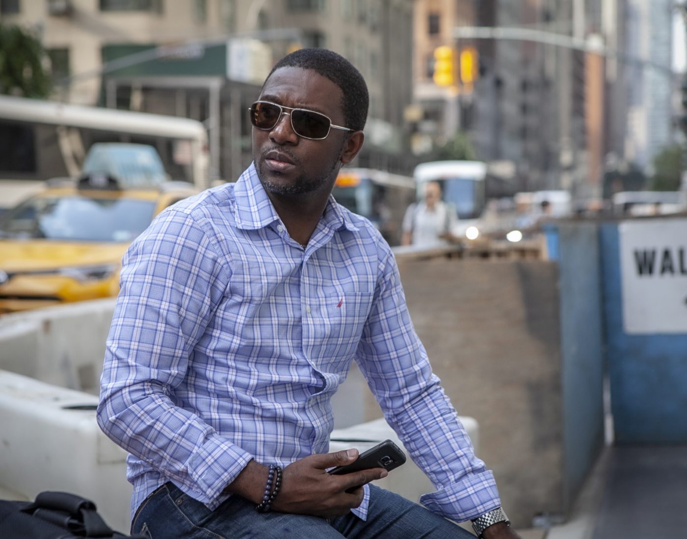 Photographer sitting on a street corner in Manhattan