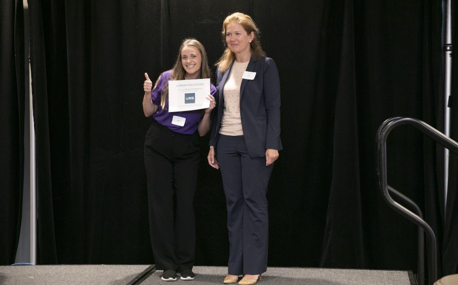 Awards photographer Toronto - certificate presentation on stage with sponsor branding
