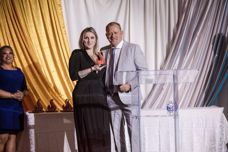 Awards night photographer Toronto - winner with trophy on stage