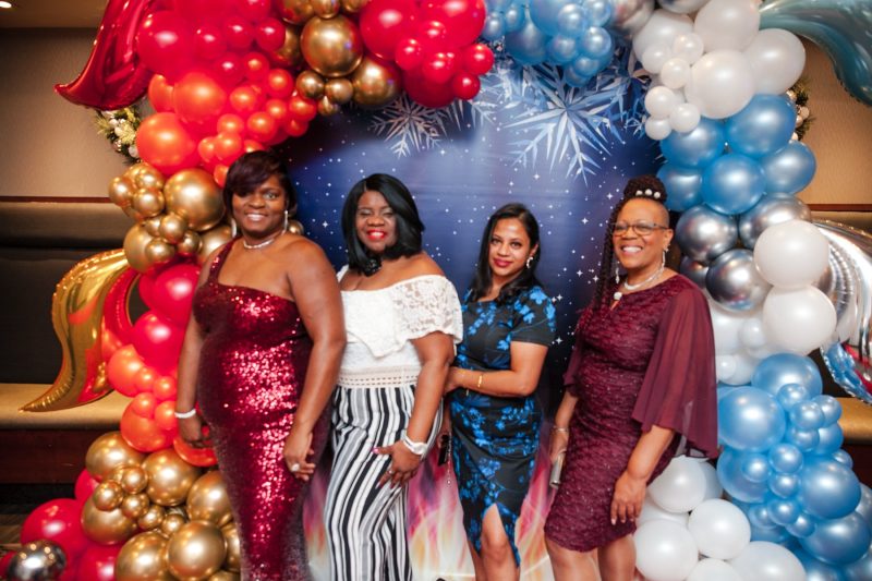 Corporate gala photographer Toronto - guests at a branded step-and-repeat backdrop